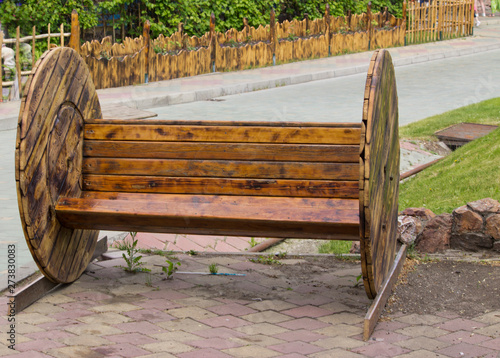 interesting wooden bench in the city Park in natural light