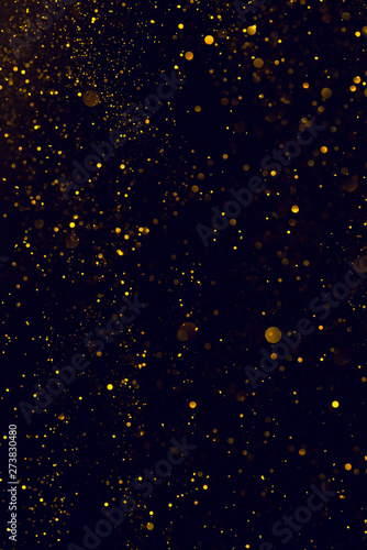 Glitter abstract background shiny particles golden dust flow