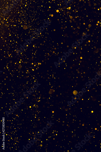 Glitter abstract background shiny particles golden dust flow
