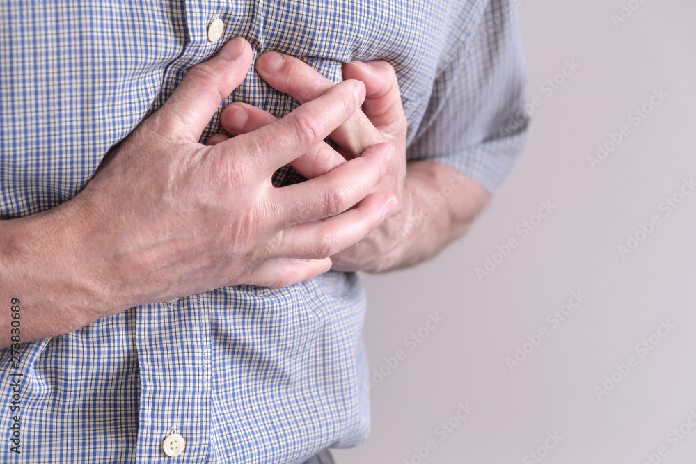 The young man is suffering from chest pain. Chest spasm, angina
