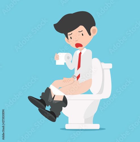 Businessman sitting on White toilet