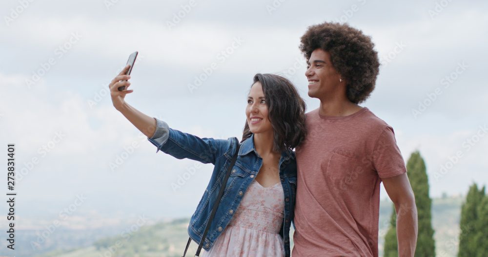Romantic couple taking a selfie with smartphone in rural town of Assisi.Portrait medium shot.Friends italian trip in Umbria.4k slow motion Romantic couple taking a selfie with smartphone in rural town of Assisi.Portrait medium shot.Friends italian trip in Umbria.4k slow motion