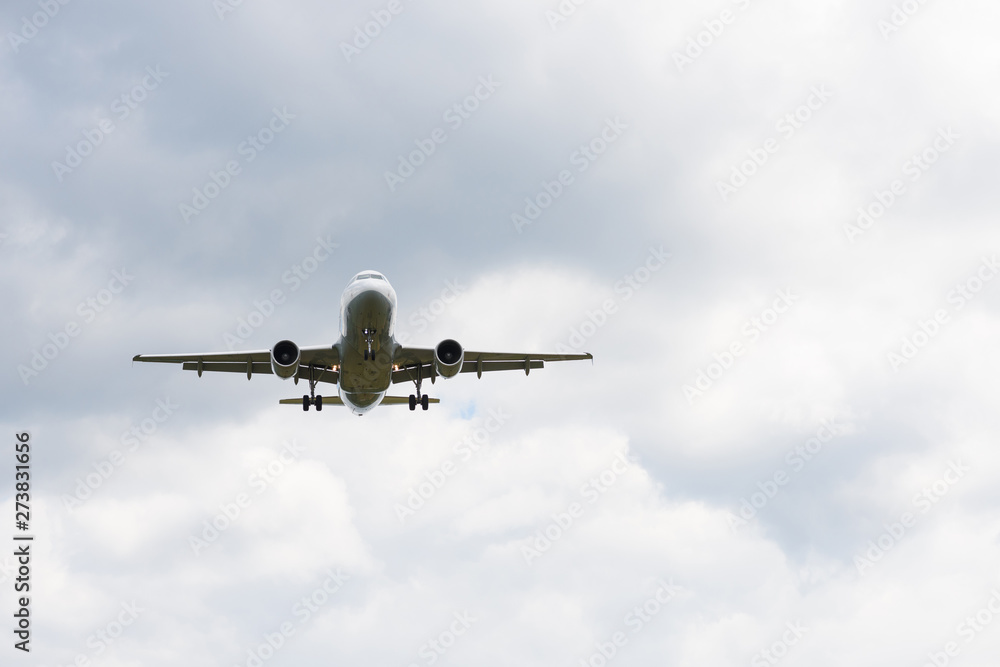 Airplane in white clouds prepare for landing.