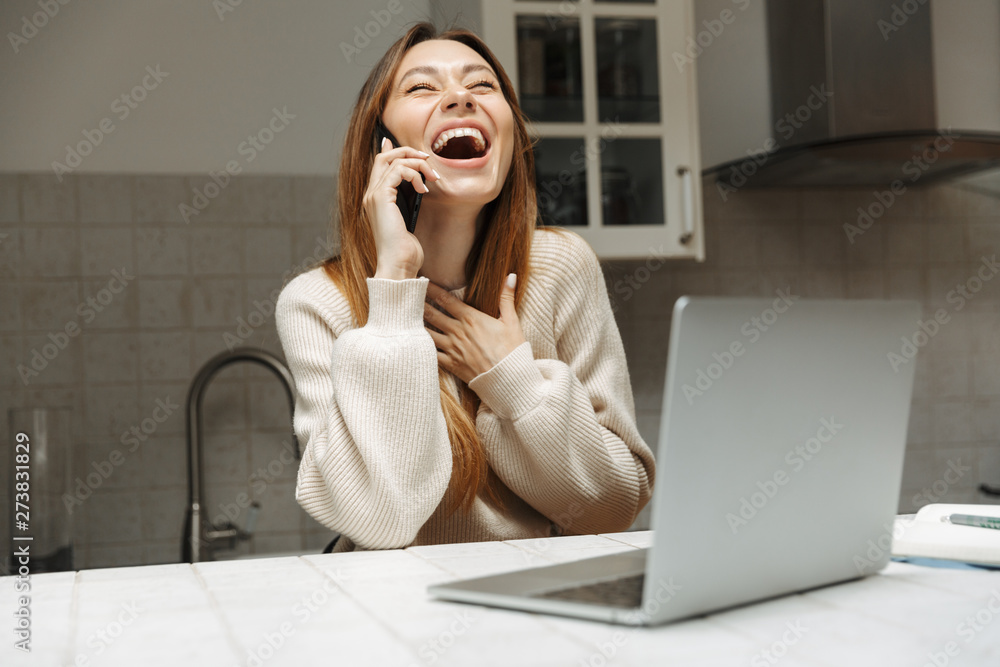 Attractive young girl sitting at the kitchen at home Attractive young girl sitting at the kitchen at home