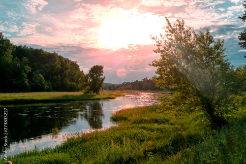 Fototapeta Naklejka Na Ścianę i Meble -  The river at sunset on a summer 