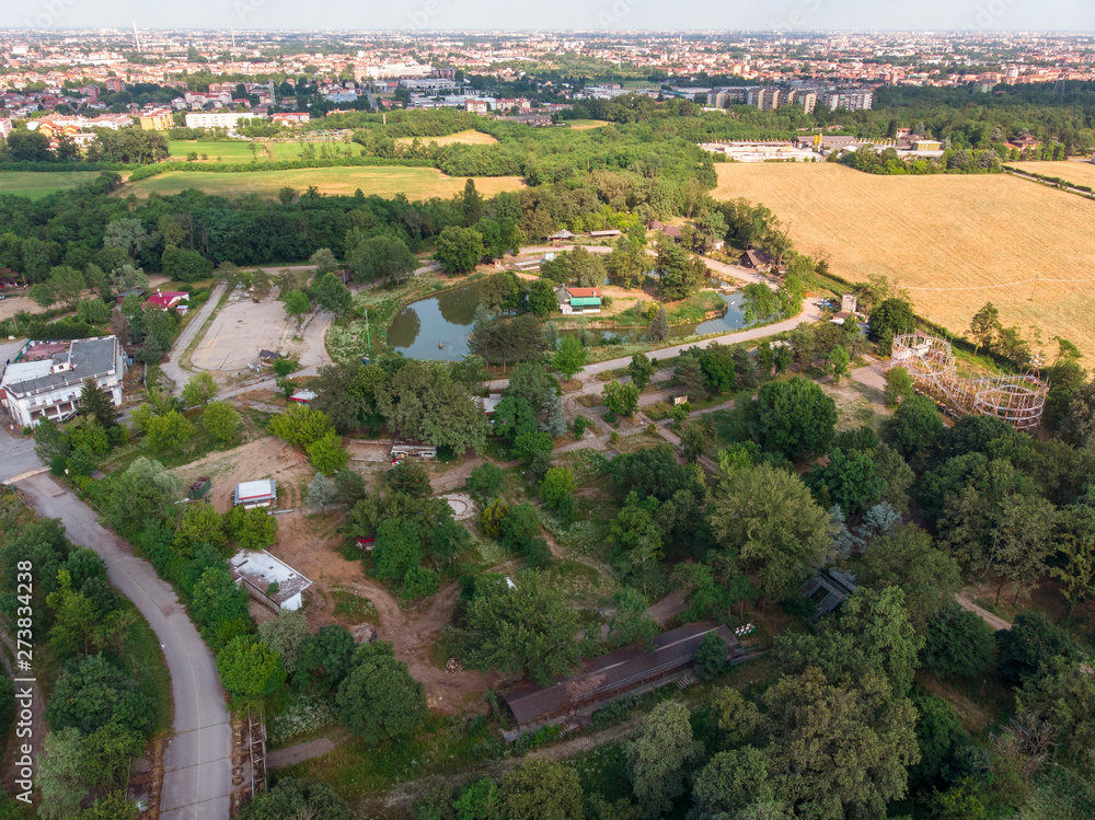 Obraz premium Nature and landscape, municipality of Solaro, Milano: Aerial view of a field, houses and homes, farming, grass green, countryside, farming, trees. Italy