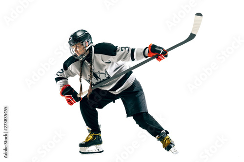 Young female hockey player with the stick isolated on white background. Sportswoman in action wearing equipment attacking for the goal or score. Concept of sport, healthy lifestyle, motion, movement.
