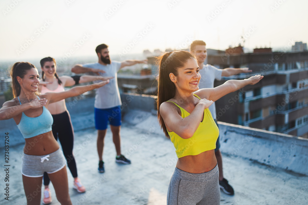Group of happy fit friends exercising outdoor in city Group of happy fit friends exercising outdoor in city