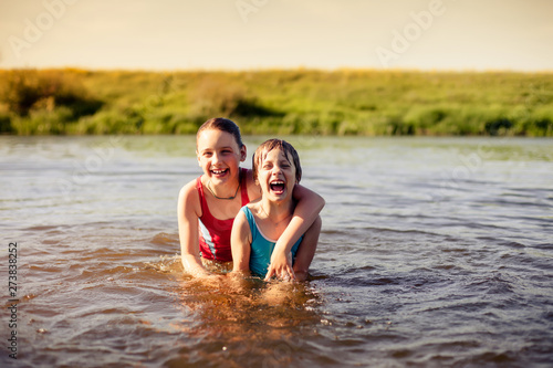 Girls bathing in   river on   summer day.