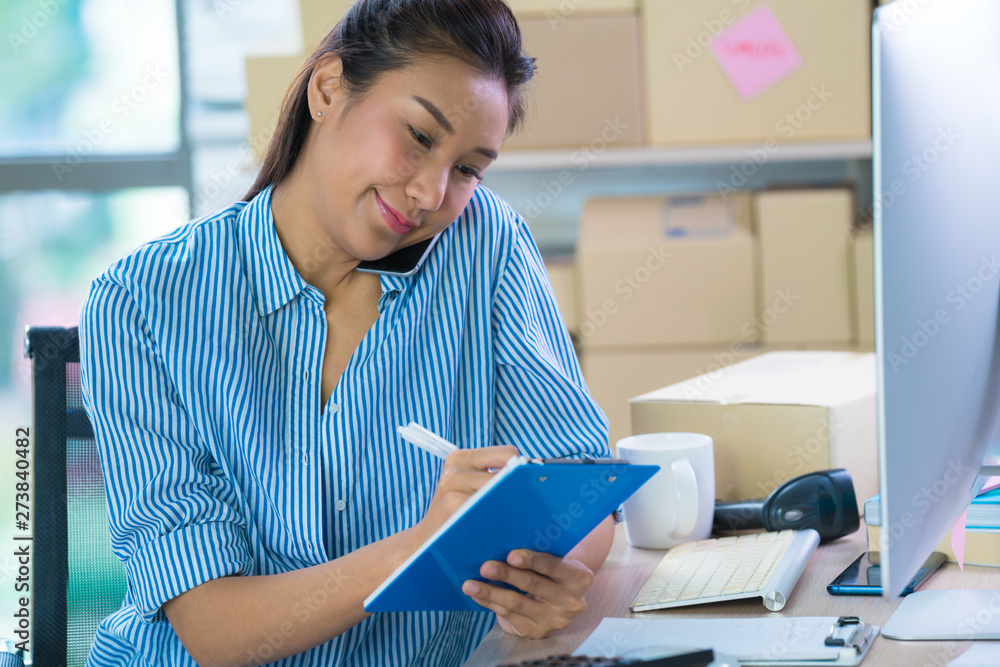 Young Asian woman entrepreneur/ Business owner using smart phone working at home Young Asian woman entrepreneur/ Business owner using smart phone working at home