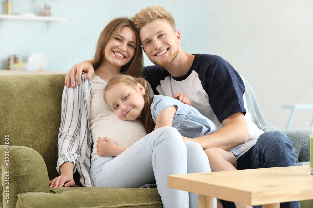 Beautiful pregnant woman with her family at home