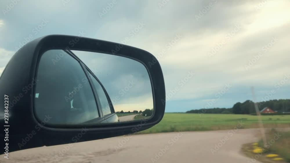 Car mirror view again from the road Car mirror view again from the road