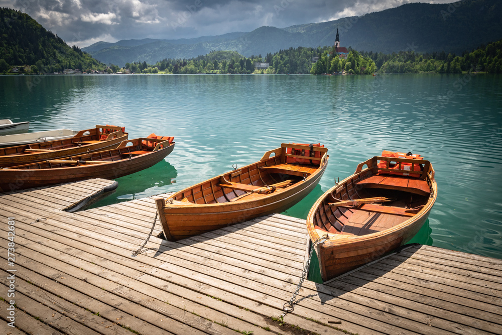 scenic view on beautiful wooden flat rowing boats on lake bled, slovenia, go green concept