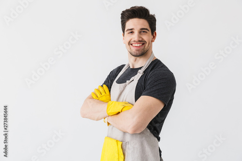 Happy young houseman househusband isolated over white wall background. photo
