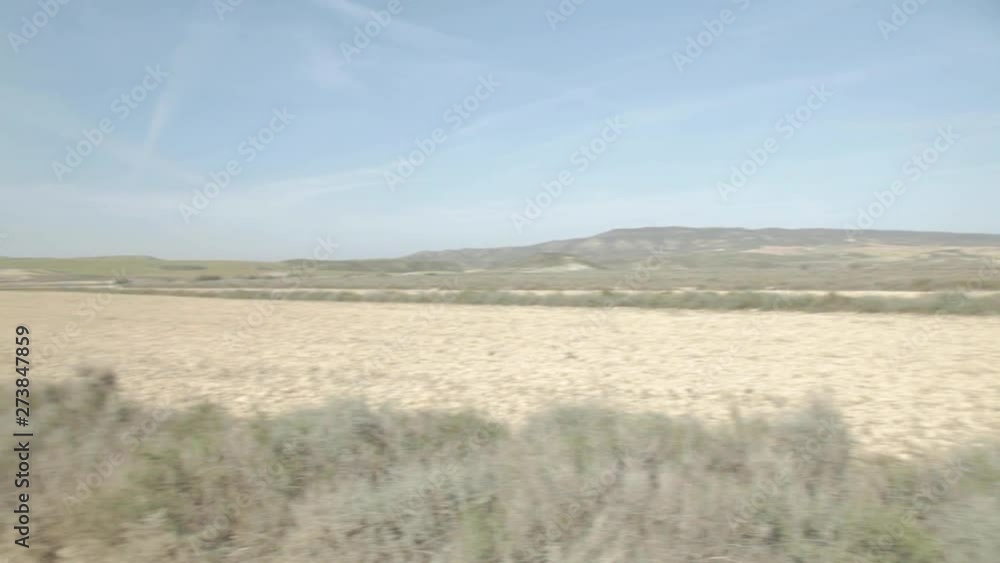 Empty desert landscape around an isolated wild road. Panorama. Sunny summer, blue sky, green nature, and mountains. Empty desert landscape around an isolated wild road. Panorama. Sunny summer, blue sky, green nature, and mountains.