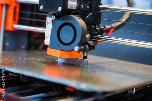 Automatic three dimensional 3d printer performs product creation. Modern 3D printing or additive manufacturing and robotic automation technology photo