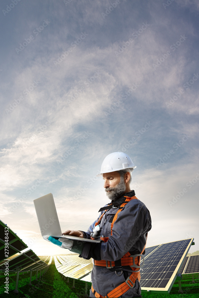 Solar energy engineer using laptop for check station Solar energy engineer using laptop for check station