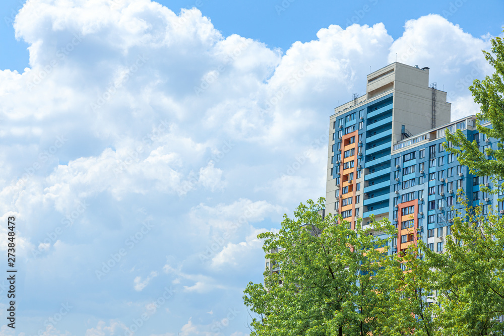 Multi-storey building against the sky with clouds. Copy space for text. Multi-storey building against the sky with clouds. Copy space for text.