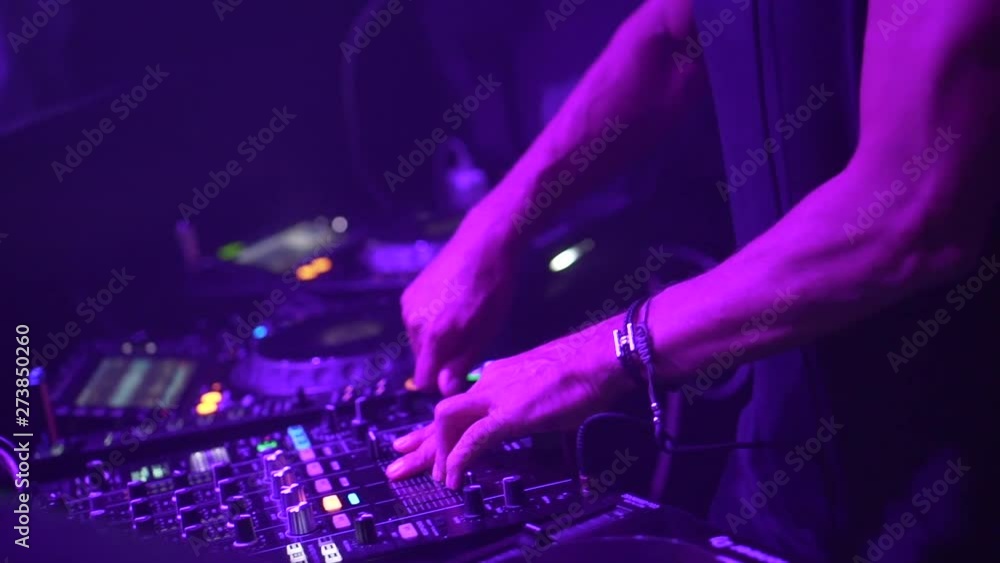 Close-up, DJ plays in the club on stage. Human hands on the audio mixer. Stands superstar Close-up, DJ plays in the club on stage. Human hands on the audio mixer. Stands superstar