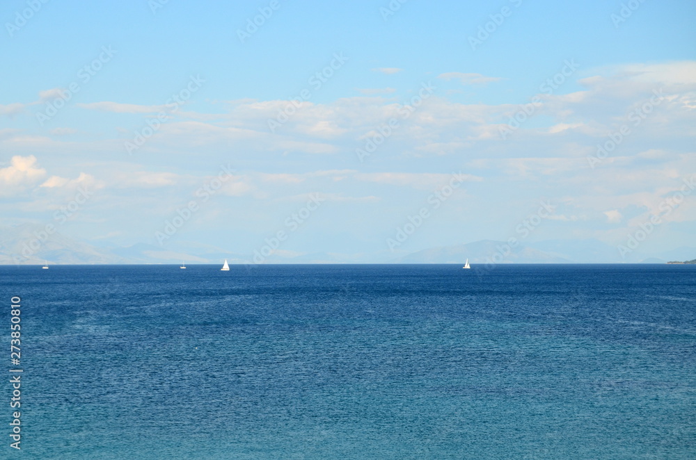 Lonely sailboat in the sea and mountain forests