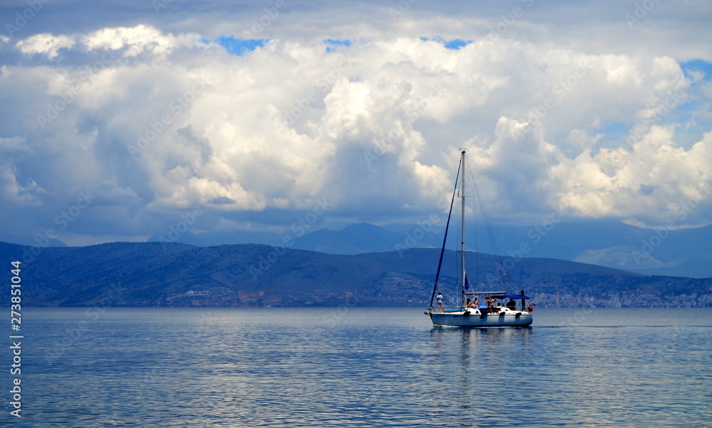 Lonely sailboat in the sea and mountain forests Lonely sailboat in the sea and mountain forests