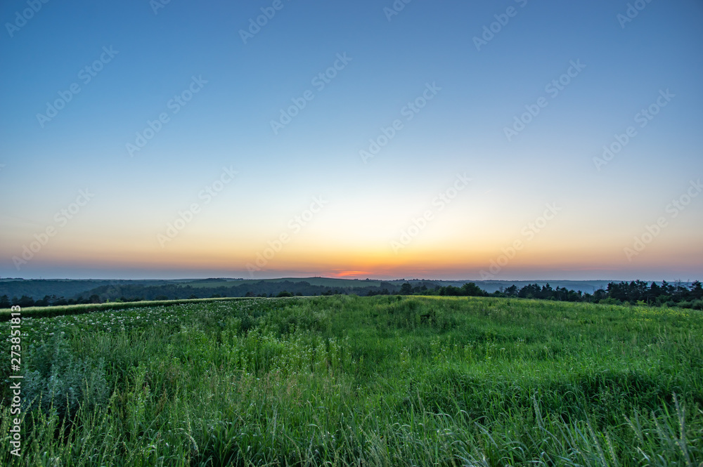 Field and hills on a summer evening