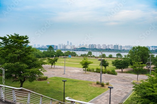 Wallpaper Mural River Park view on a cloudy day with skylines of the other side of the river. Torontodigital.ca