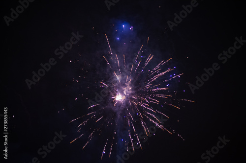 Explosive and colorful holiday fireworks at night sky.