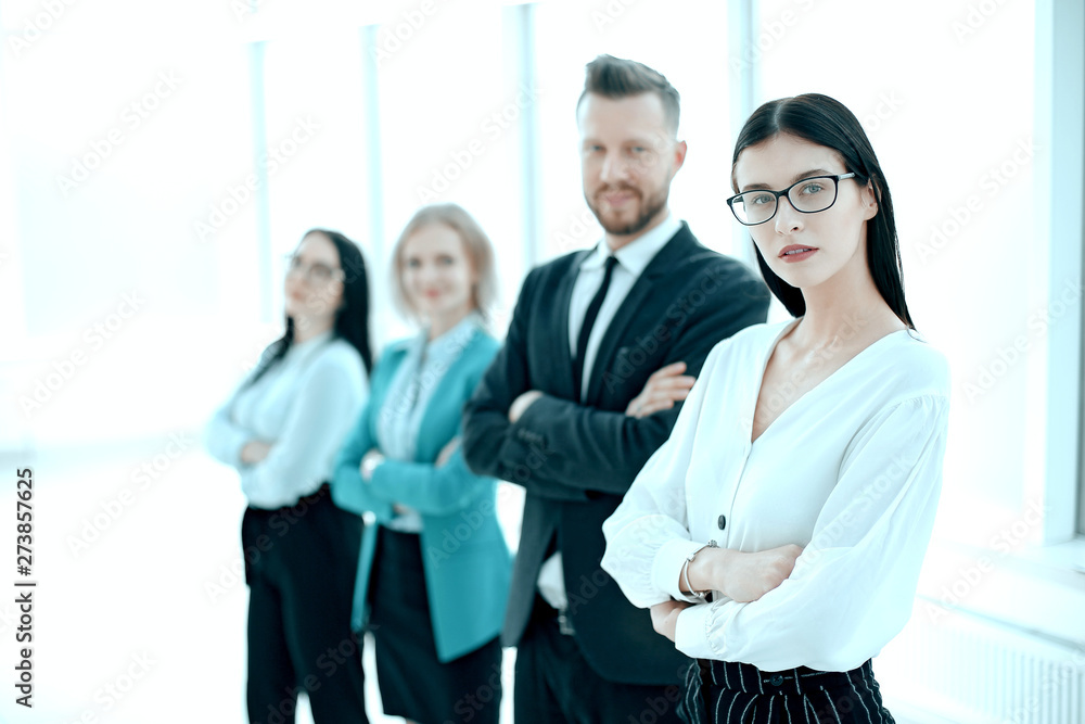 successful business woman standing in front of her business team successful business woman standing in front of her business team