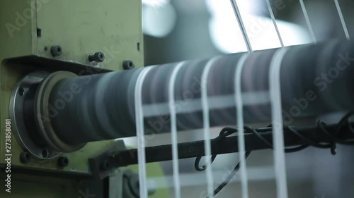 Label Shapes Printing Rolls with High speed labeling machine in industrial factory, sticker on product in manufacture. Flexible packaging. Close Up Tilt Up.