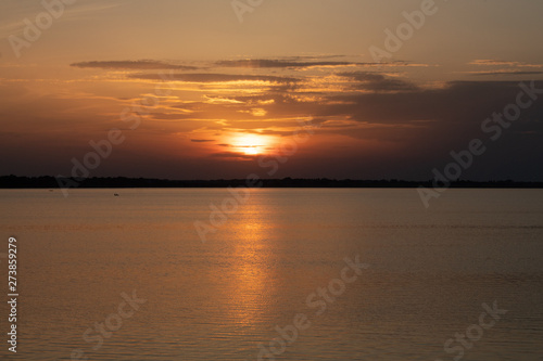 Sunset on the lake, reflection in the water, sun path, © Lyudmyla