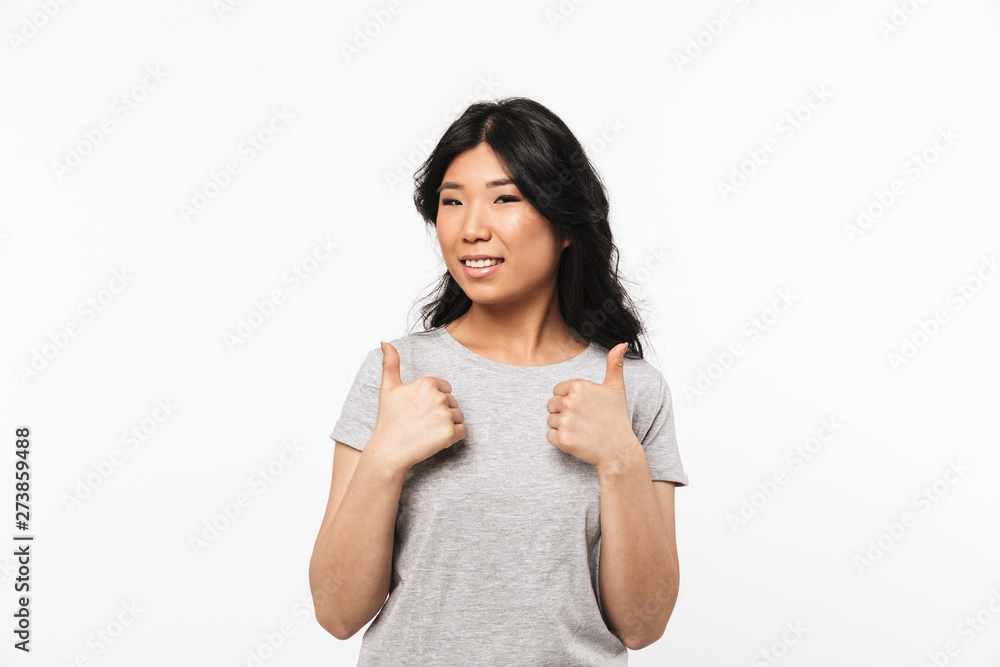 Asian beautiful young woman posing isolated over white wall background showing thumbs up gesture. Asian beautiful young woman posing isolated over white wall background showing thumbs up gesture.