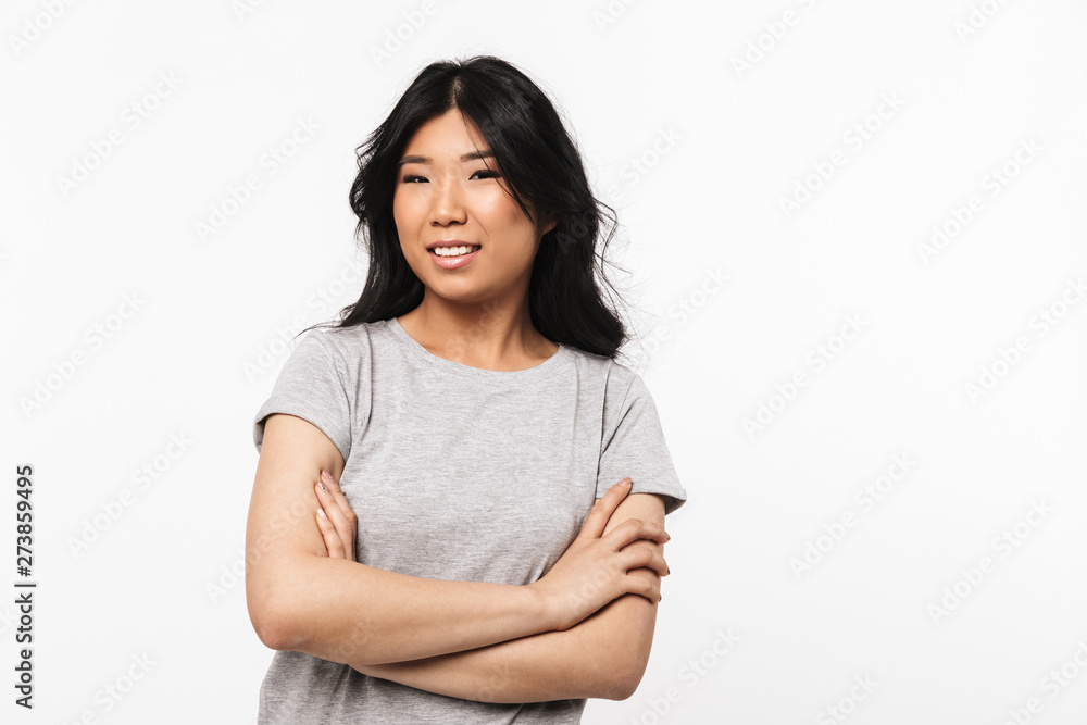 Asian beautiful young woman posing isolated over white wall background. Asian beautiful young woman posing isolated over white wall background.