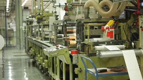 Metal Label Printing Rolls with High speed labeling machine in industrial factory, sticker on product in manufacture. Flexible packaging. Wide handled Shot.