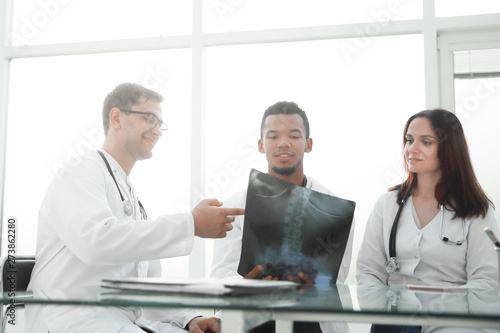 employees of the medical center discussing the x-ray of the patient