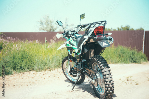 motocross bike stands on a sandy road
