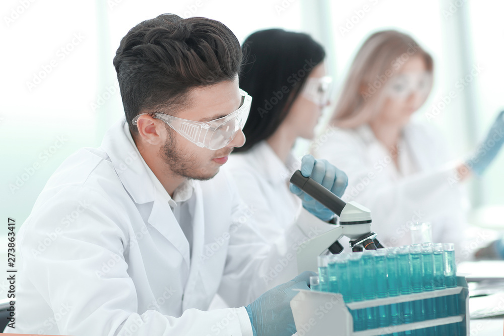 close up.male scientist conducting research in the laboratory close up.male scientist conducting research in the laboratory