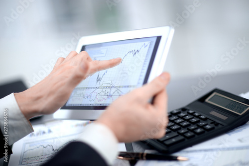 close up.businessman pointing at digital tablet screen
