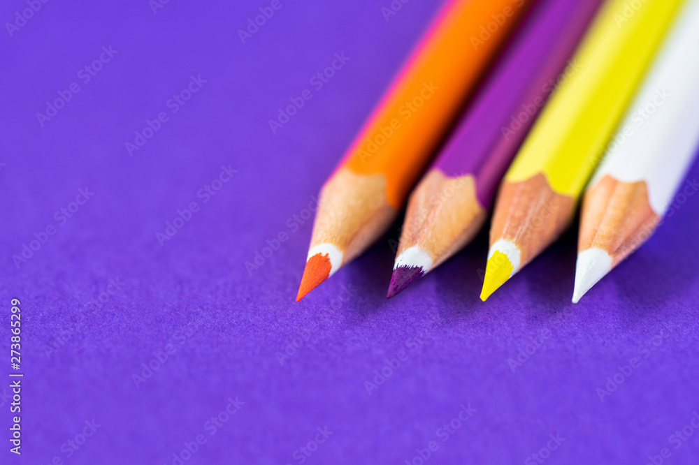 colored pencils on a violet background with space for text. colored pencils on a violet background with space for text.