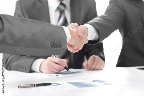 Wallpaper Mural close up.handshake of financial partners after signing the contract Torontodigital.ca