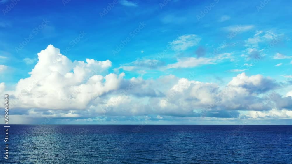 aerial drone shot cinematic background of clear blue open ocean and bright blue sky with majestic  white clouds Gulf of Thailand,