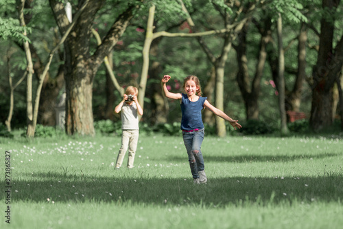 brother and sister play meadow in summer day