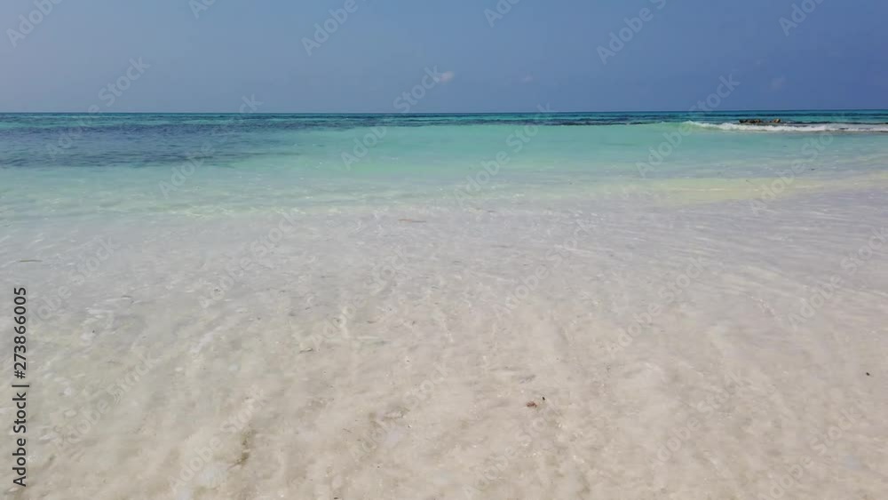 panning left shot of beautiful crystal clear sea water revealing desert island vegetation panning left shot of beautiful crystal clear sea water revealing desert island vegetation