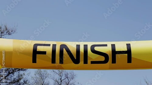Word Finish on a yellow inflatable banner against a blue sky.