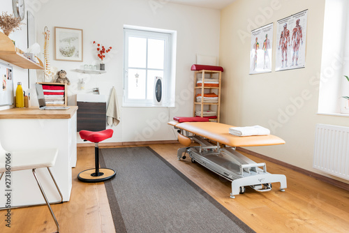 Therapist treating injured knee of athlete fermale patient - sport physical therapy concept, panoramic banner