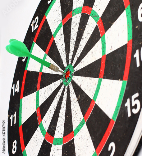 Arrow dart hitting the center of the target dart Board