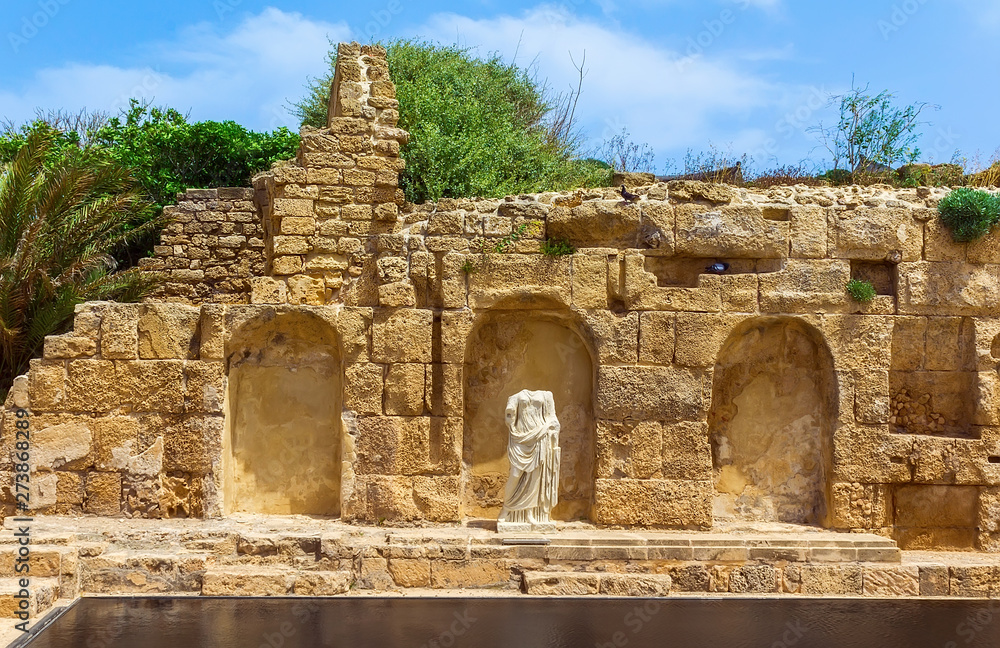 Ancient construction and statue. city of Caesarea Israel