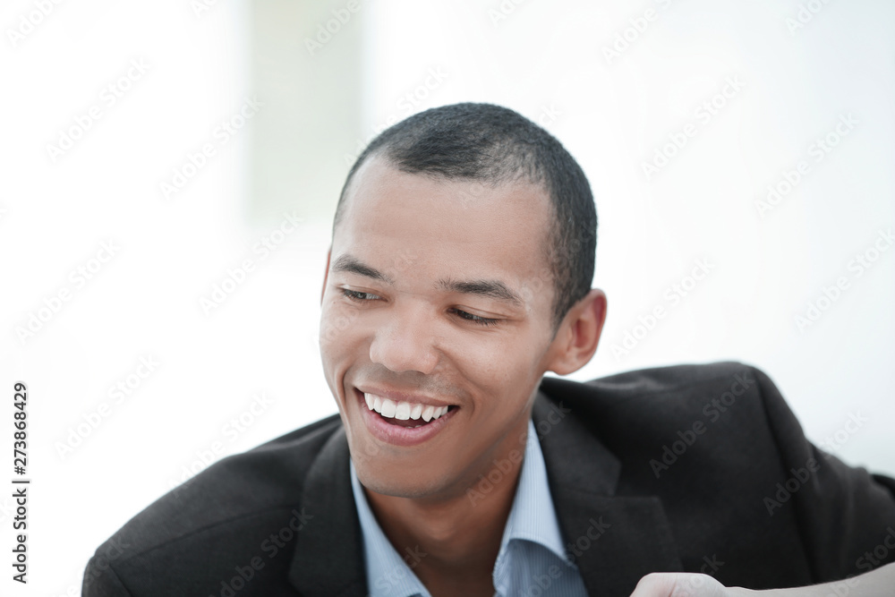 closeup.portrait of a young businessman on a light background closeup.portrait of a young businessman on a light background
