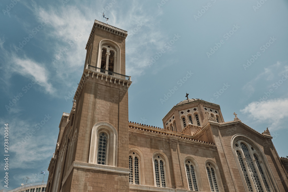 view of Metropolitan Cathedral of Athens in a sunny day with clear blue sky and clouds - Greece.