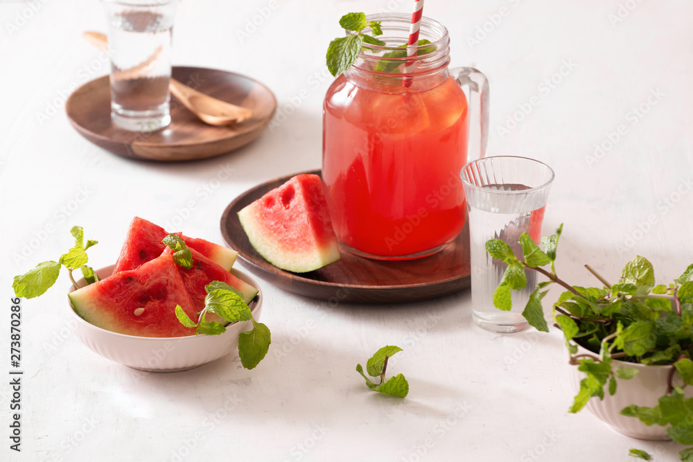 Watermelon drink in glass with slices of watermelon on whitebackground Watermelon drink in glass with slices of watermelon on whitebackground